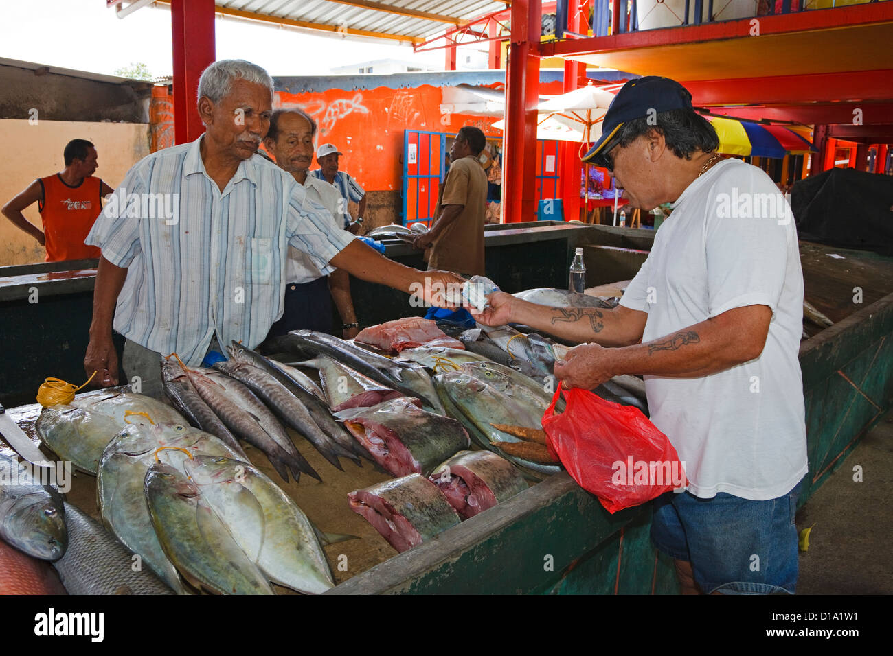 Man buying fish from a stall at the Sir Selwyn Clark Fish Market