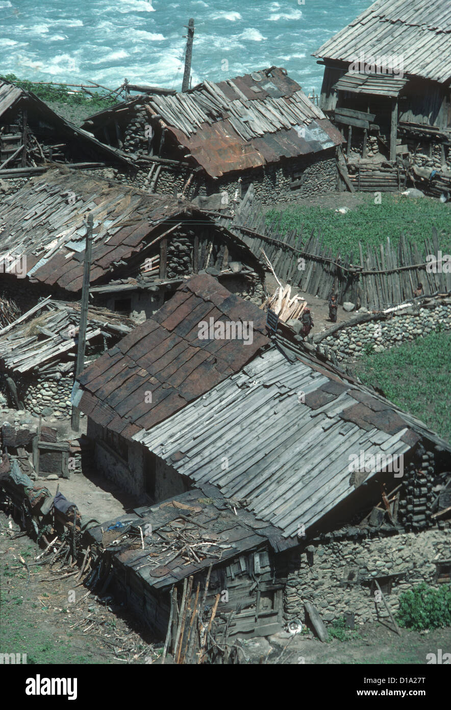Kashmir, Sind Valley. Village houses beside fast flowing river Sind Stock Photo