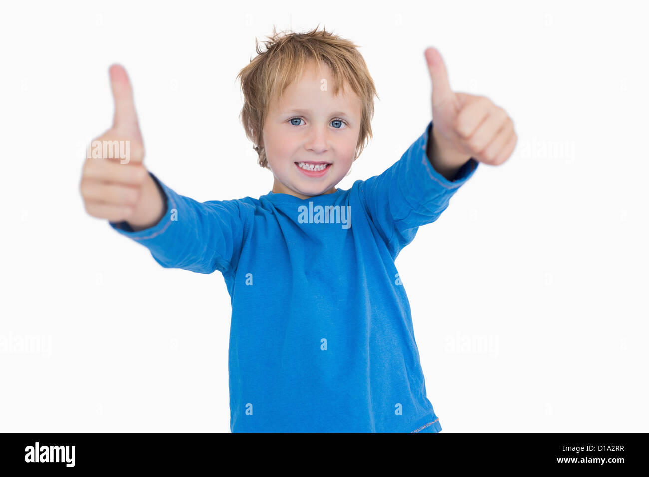 Portrait of young boy gesturing double thumbs up Stock Photo - Alamy