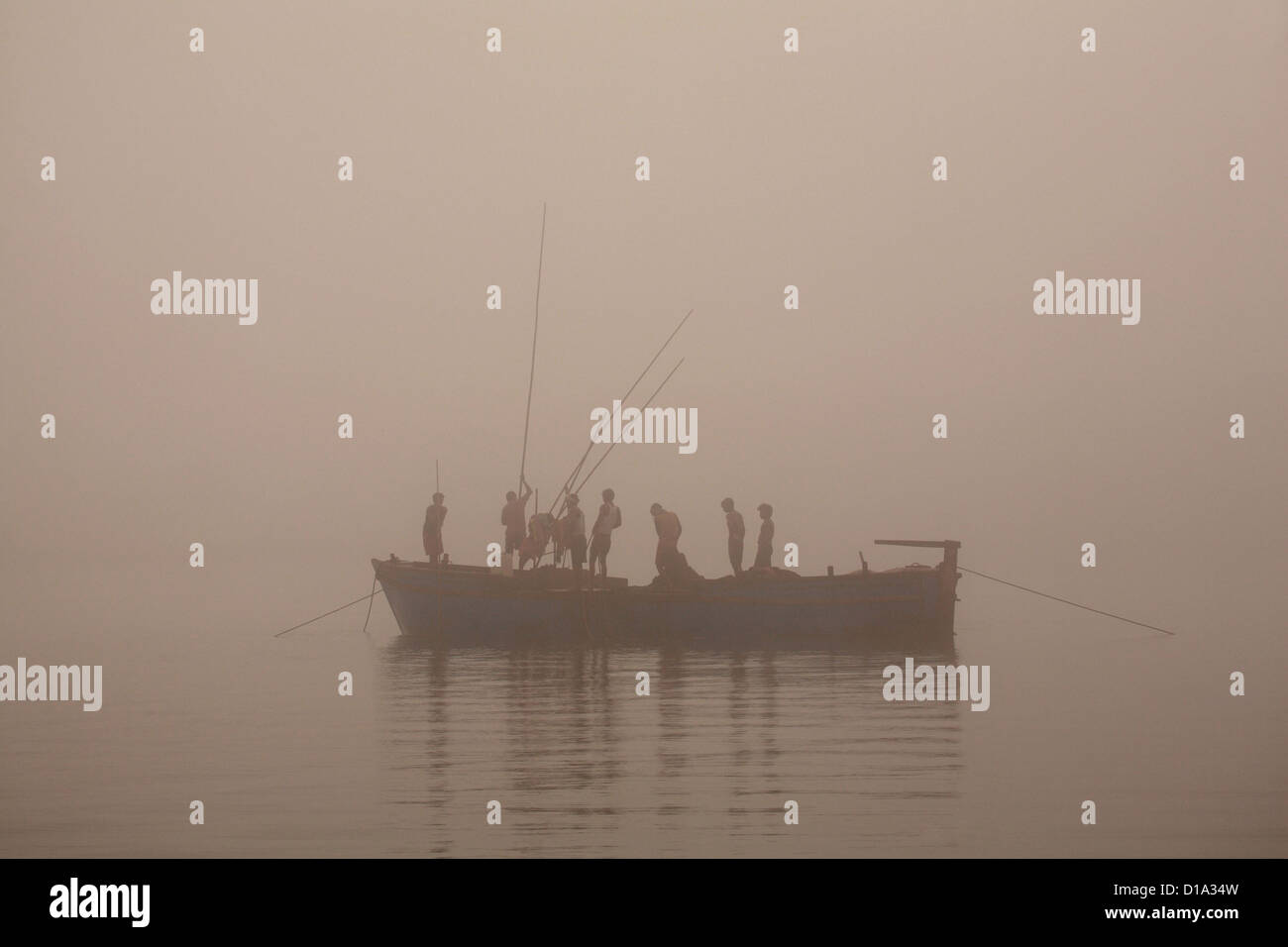 Local sand mining boat in mist, Goa Stock Photo