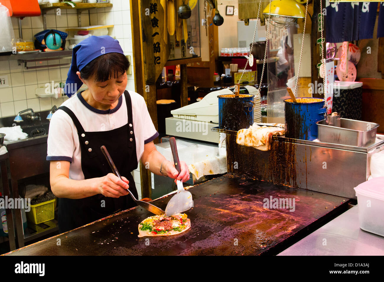 KYOTO, JAPAN Japanese pancakes (Okonomiyaki) being prepared in the open
