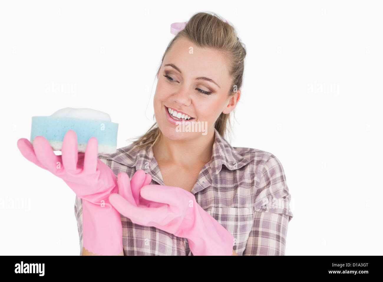 Smiling young woman holding soap suds over sponge Stock Photo Alamy