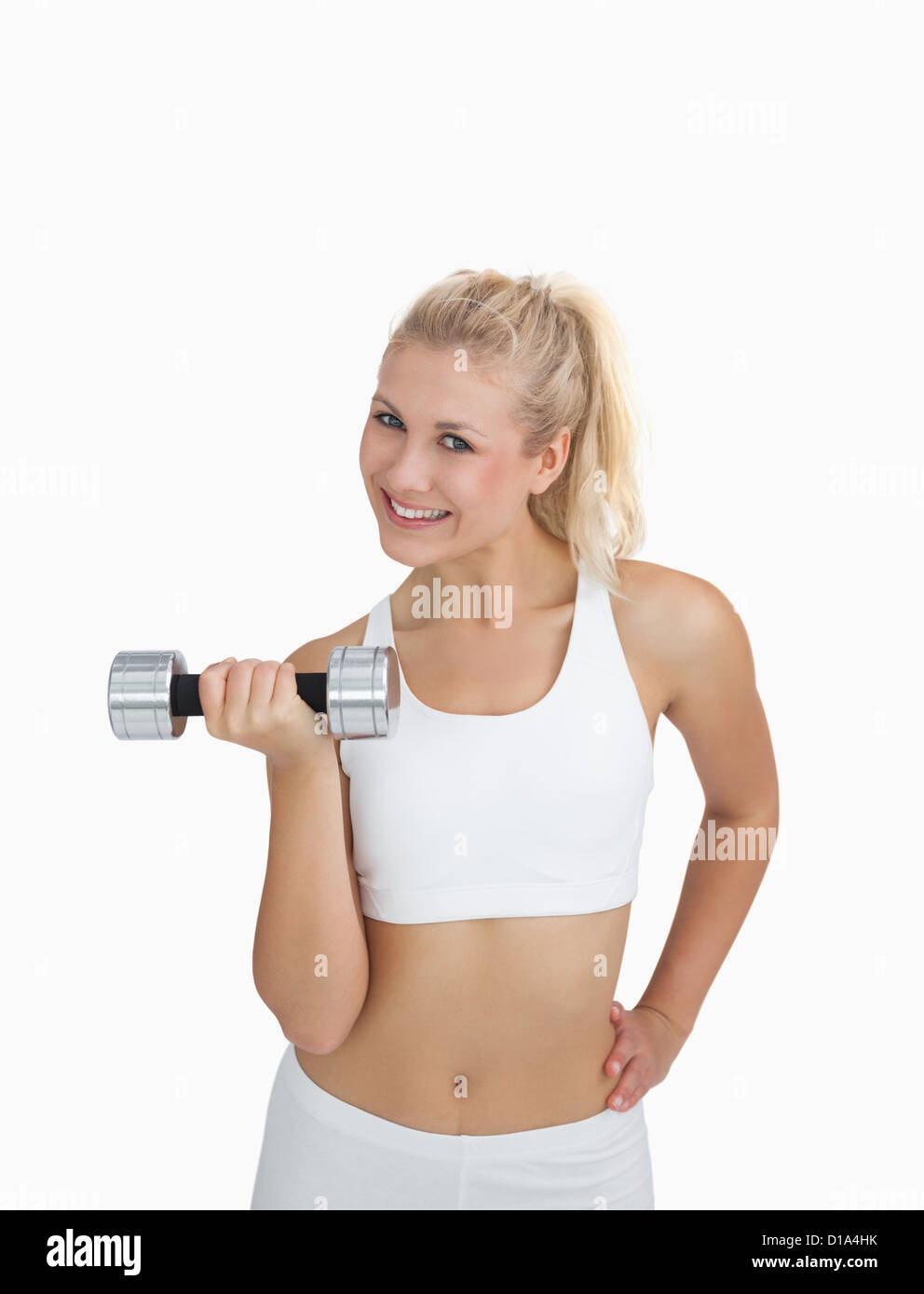 Portrait of young woman exercising with dumbbell Stock Photo - Alamy