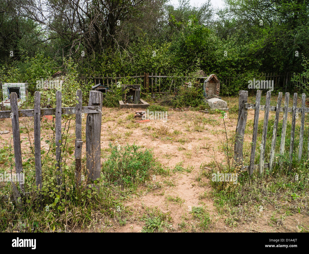 An old private family graveyard surrounded by dilapidated wooden picket