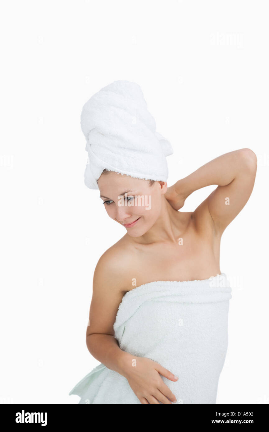 Happy young woman wrapped in towel Stock Photo - Alamy