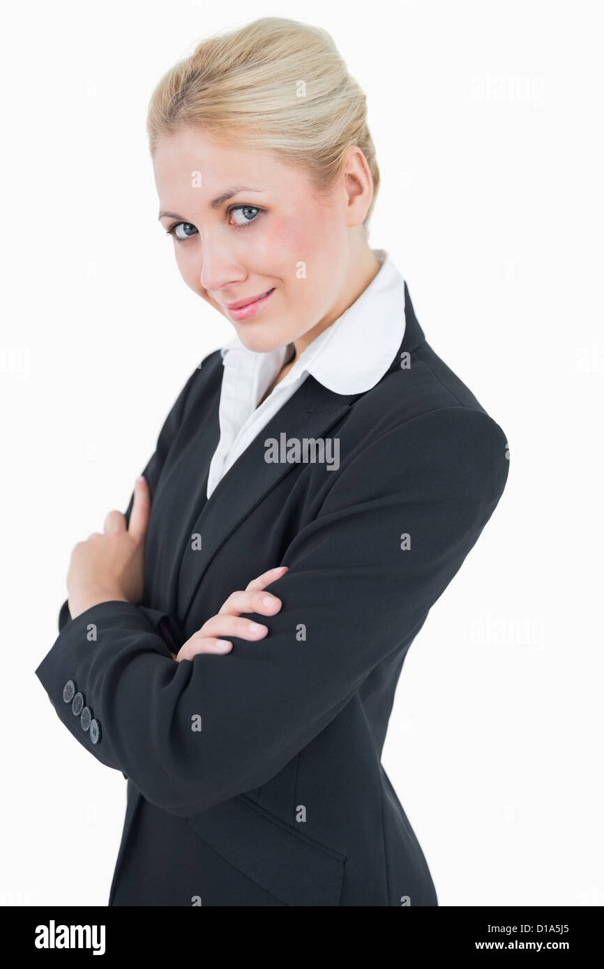 Portrait of confident young business woman standing with arms crossed ...