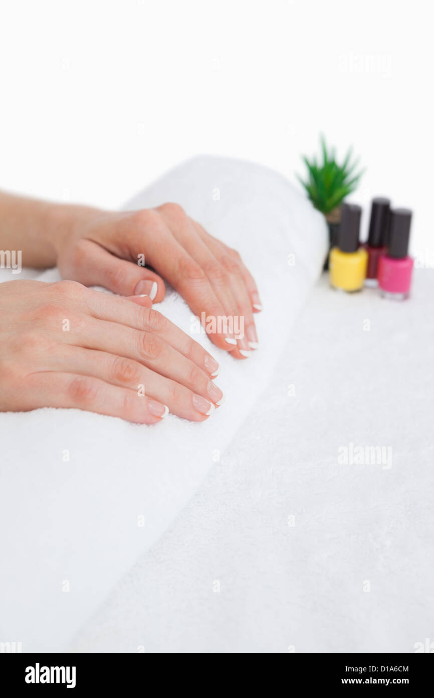 French manicured fingers and nail paint bottles Stock Photo