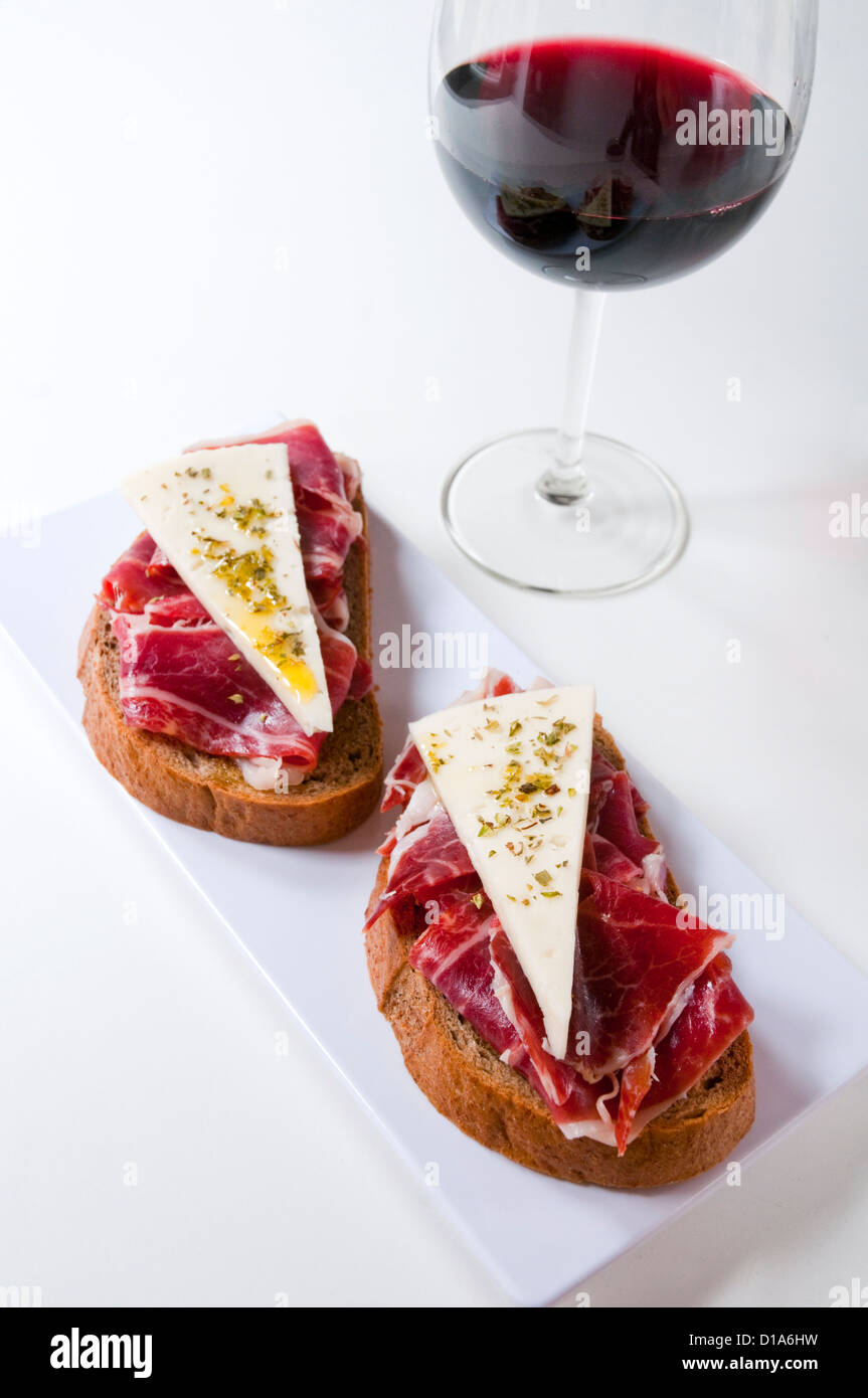 Spanish tapa: Iberian ham with cheese, oregano and olive oil. Spain ...