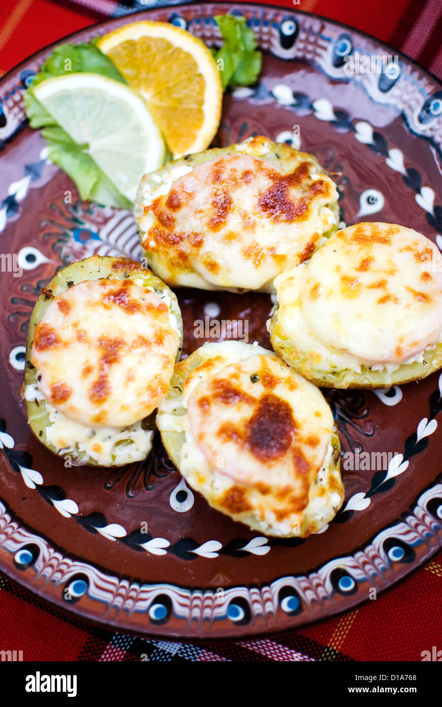 sliced potatoes covered with ham and cheese Stock Photo - Alamy