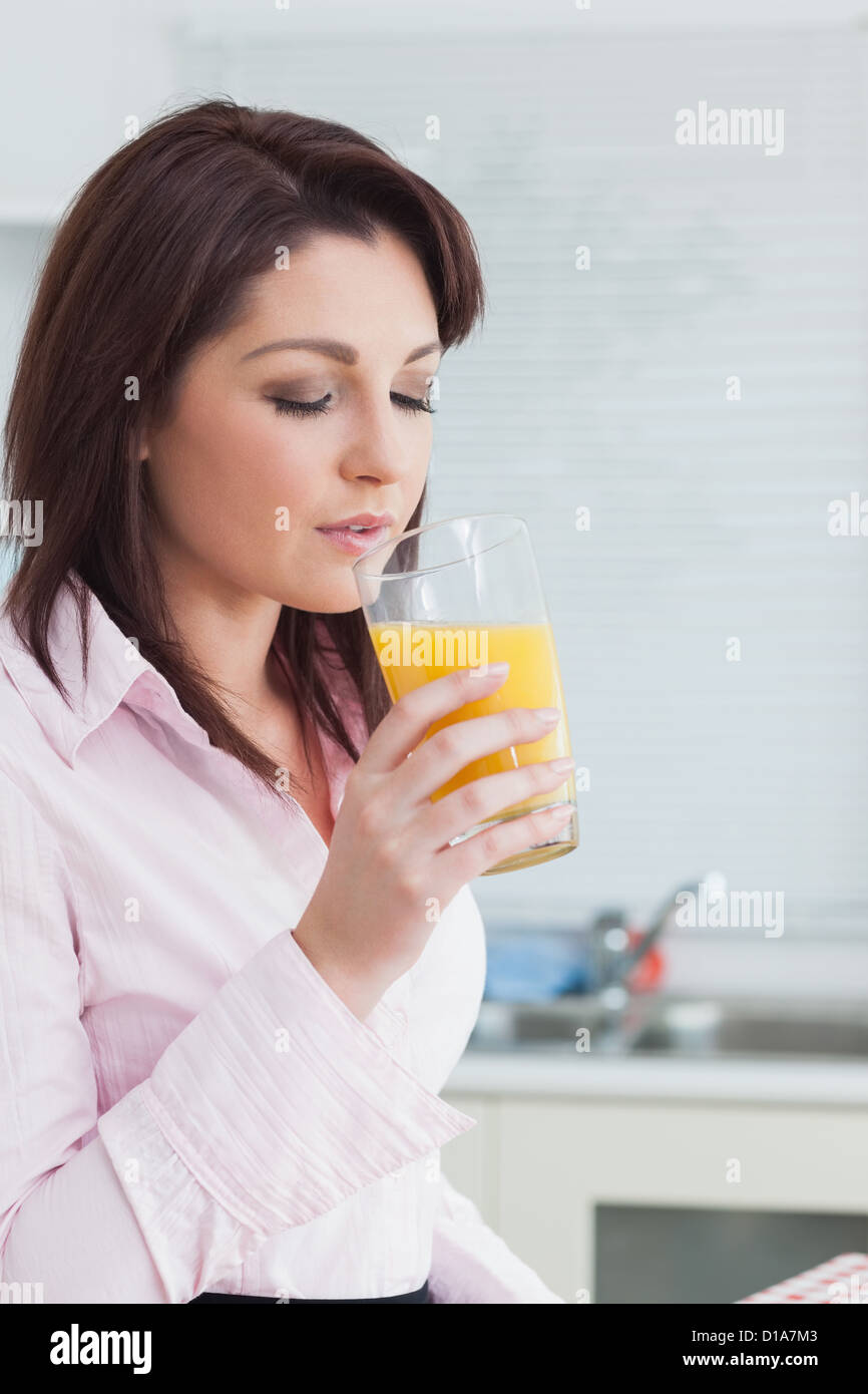 Woman drinking orange juice Stock Photo Alamy