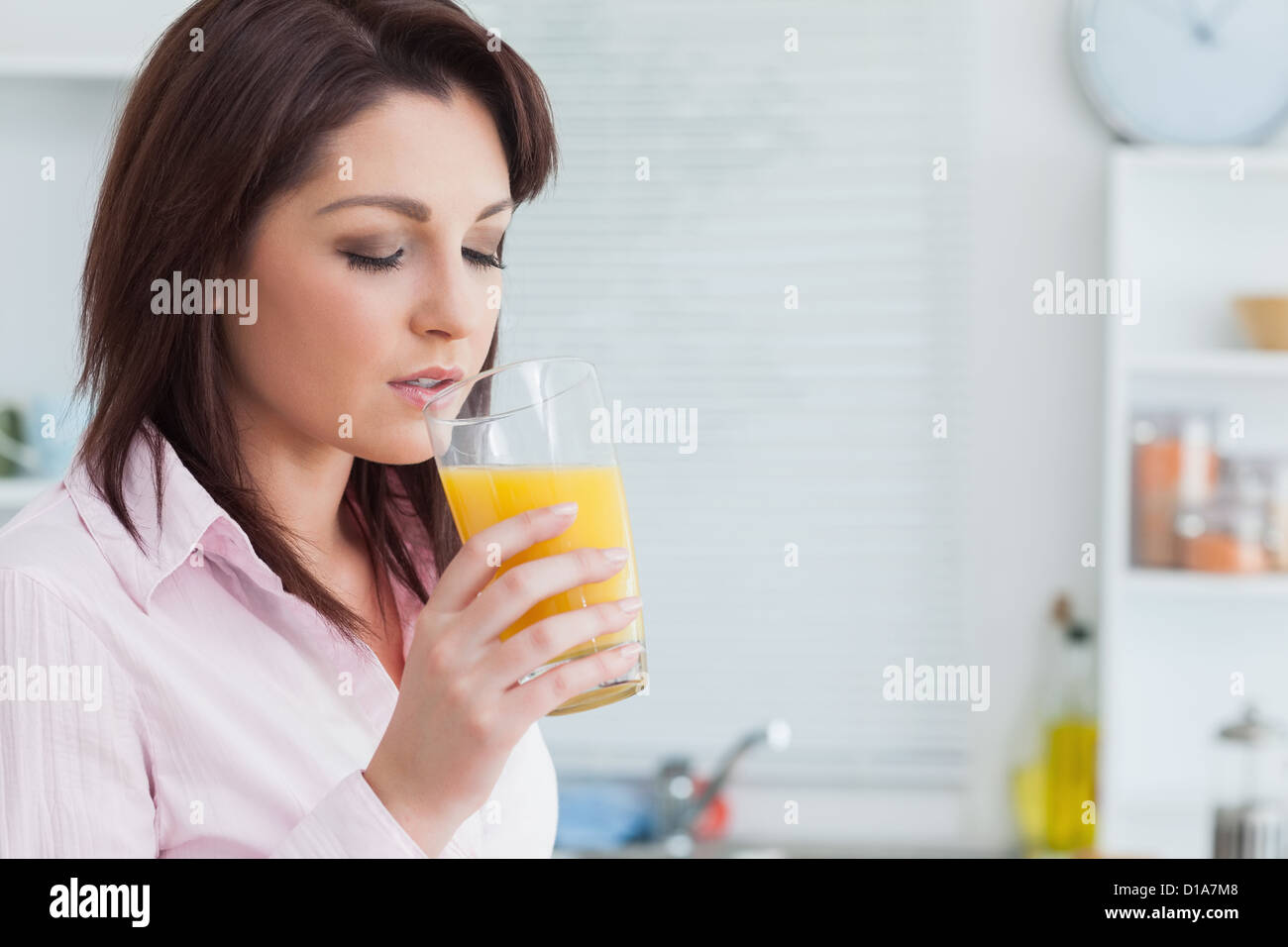 Woman drinking orange juice Stock Photo Alamy
