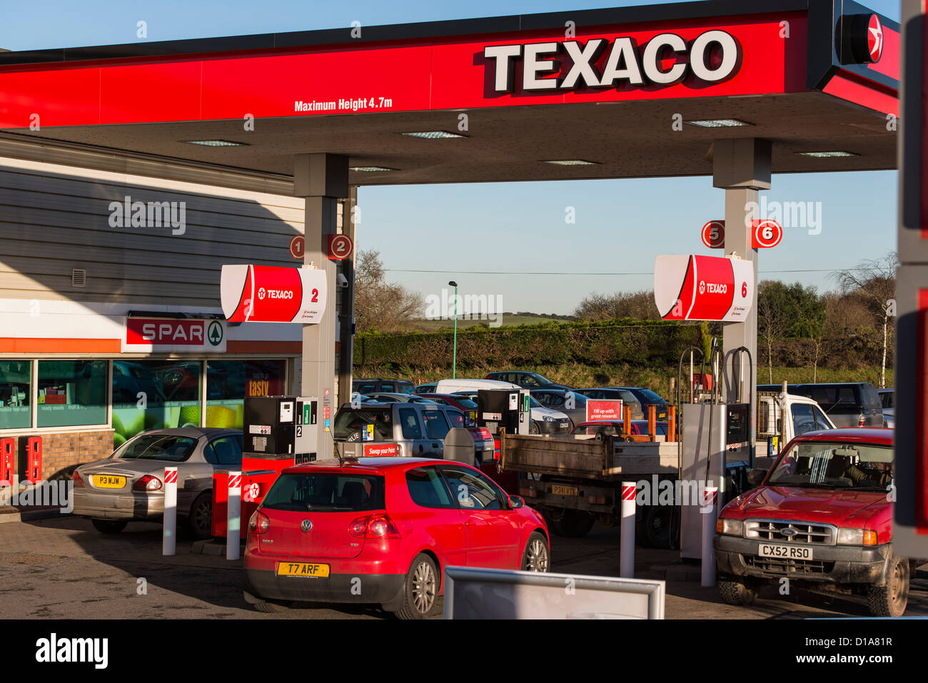 Okehampton, Devon, England.December 10th 2012. Texaco petrol gas station with cars automobiles filling up with petrol or diesel. Stock Photo