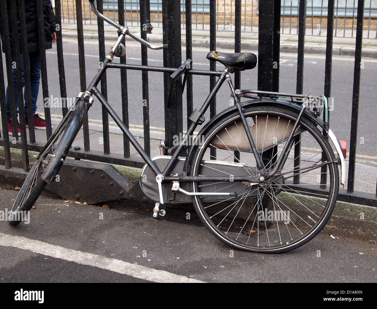 An old but used bike securely fixed to railings at Borough Market, London SE1, England, UK Stock Photo