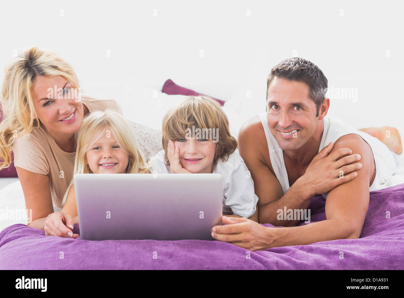 Smiling family using laptop Stock Photo - Alamy