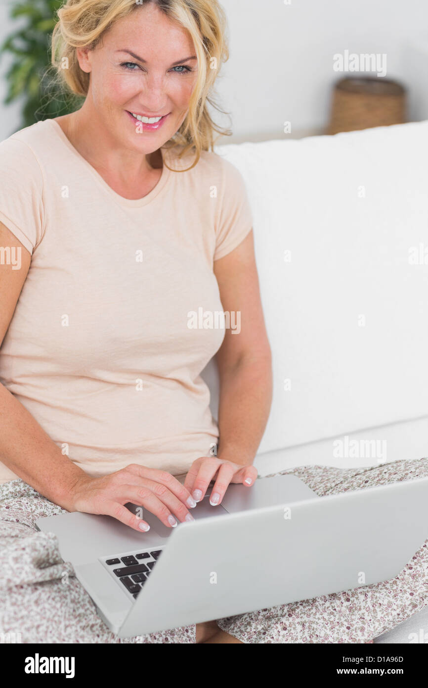 Blonde woman using a laptop Stock Photo - Alamy