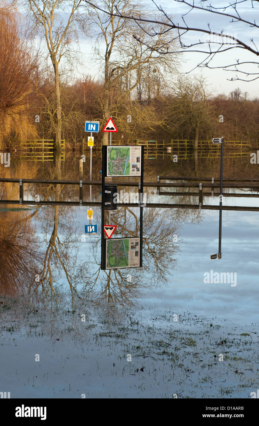 Flooded car park with tree reflection near river Thames Wallingford