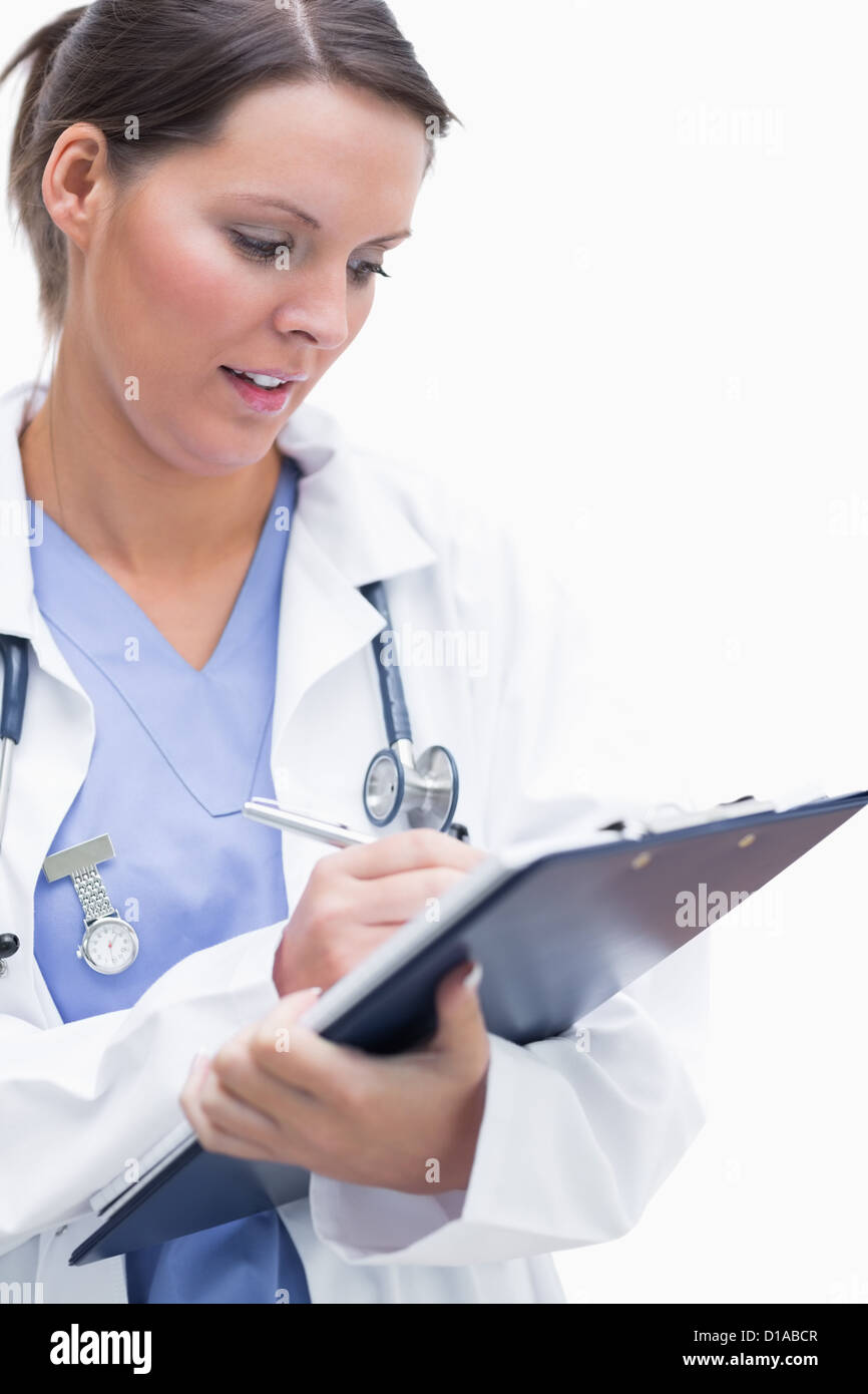 Female doctor writing on clipboard Stock Photo - Alamy
