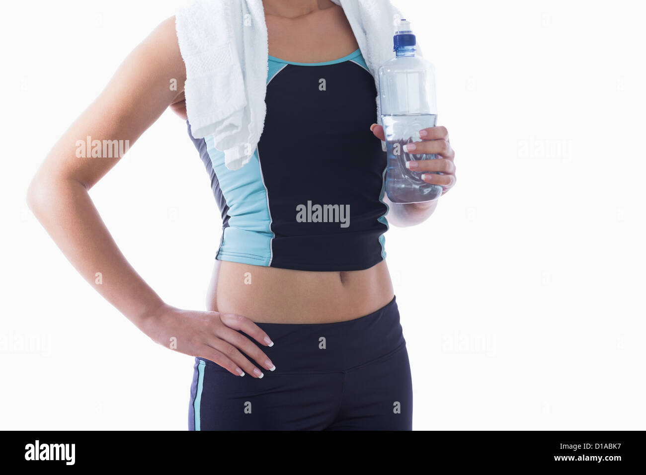 Sporty woman with towel around neck and water bottle Stock Photo - Alamy