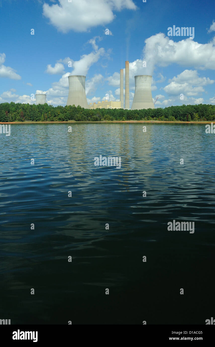 A photograph of a power plant faded into the distance of a photograph of pond. Stock Photo