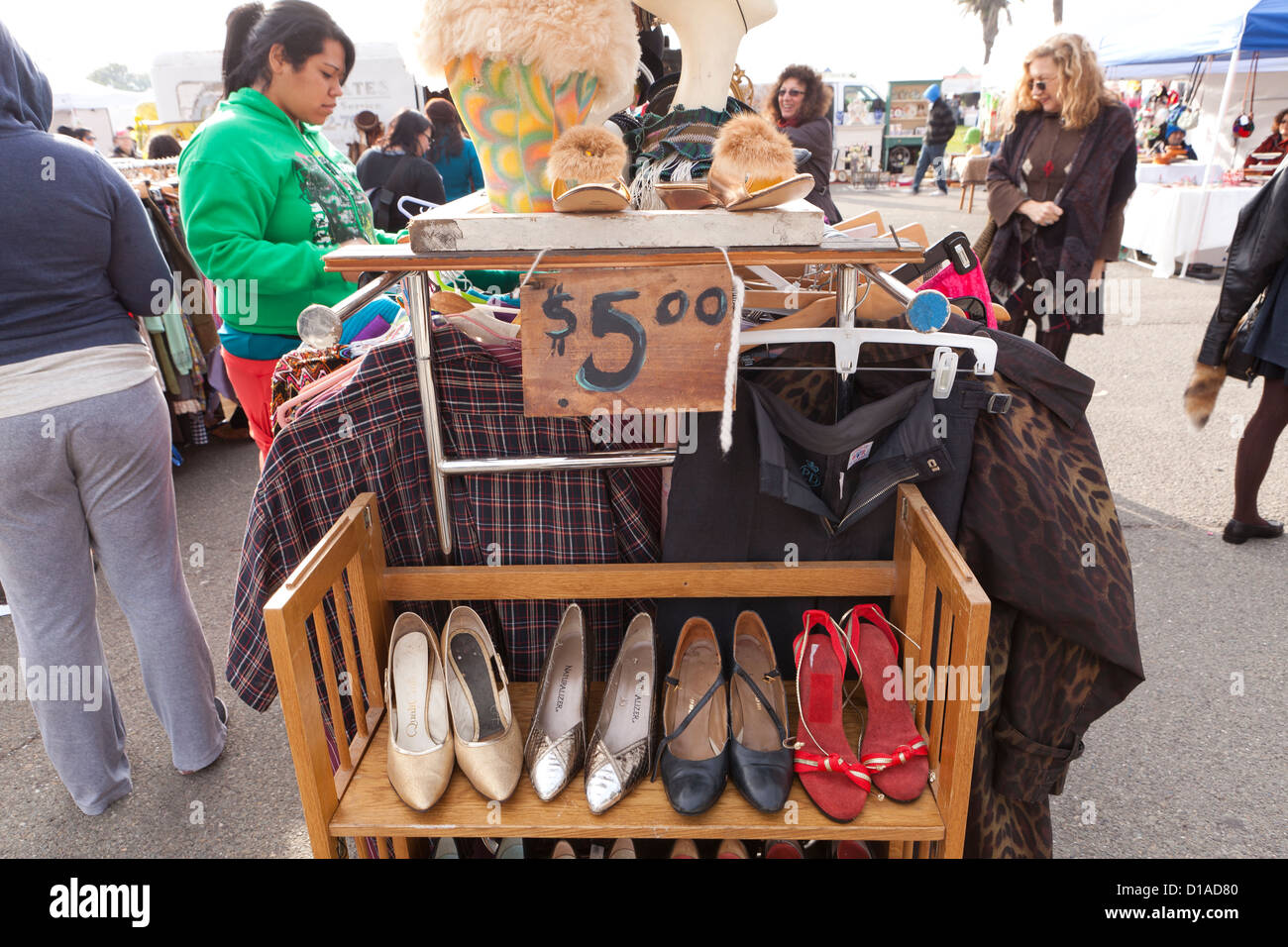 Ladies shoes and clothes on rack at an outdoor flea market - USA Stock Photo