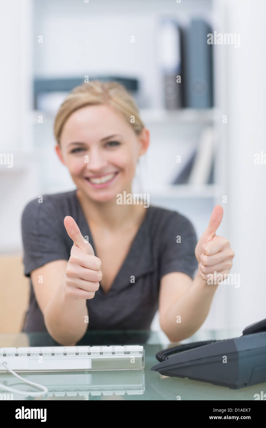 Female Executive Gesturing Double Thumbs Up At Office Stock Photo Alamy