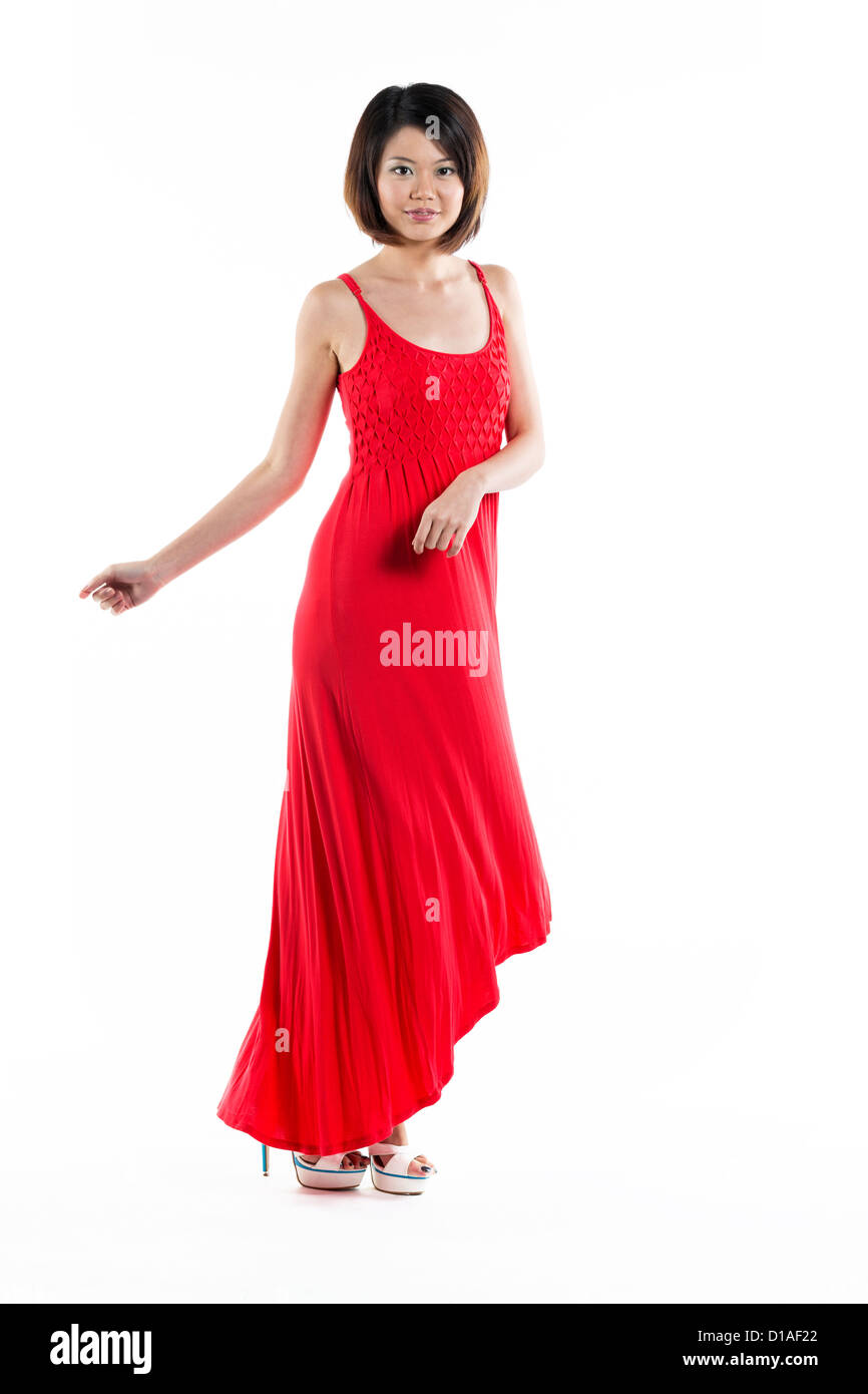 Happy Chinese woman wearing red summer dress. Energetic full length portrait of a young beautiful woman. isolated on white backg Stock Photo