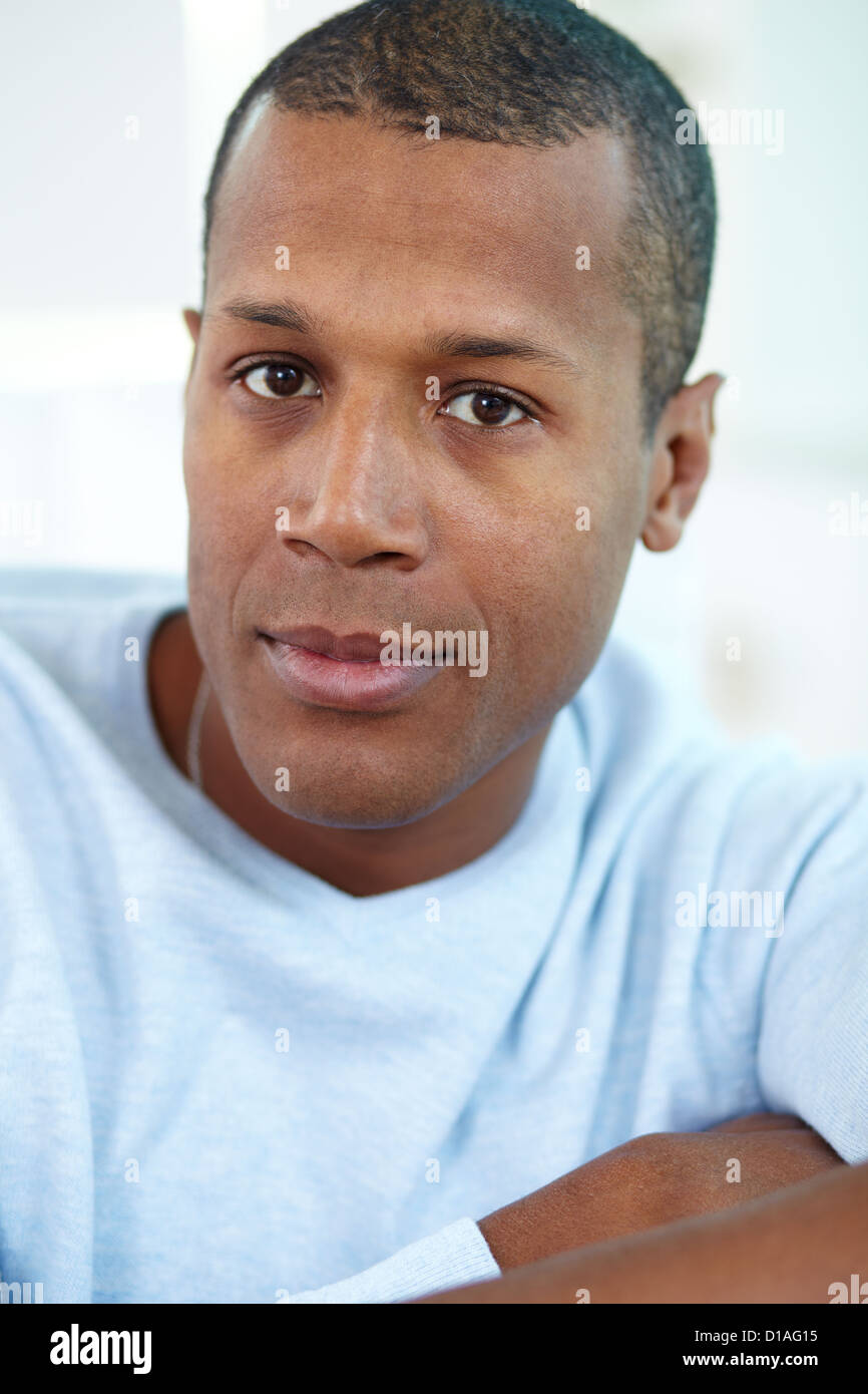 Image of young African man looking at camera with calm expression Stock ...