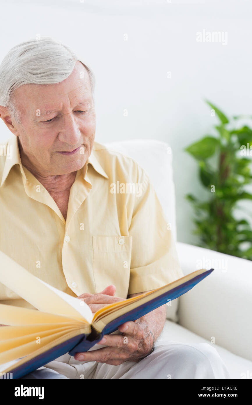 Elderly man watching his pictures Stock Photo - Alamy