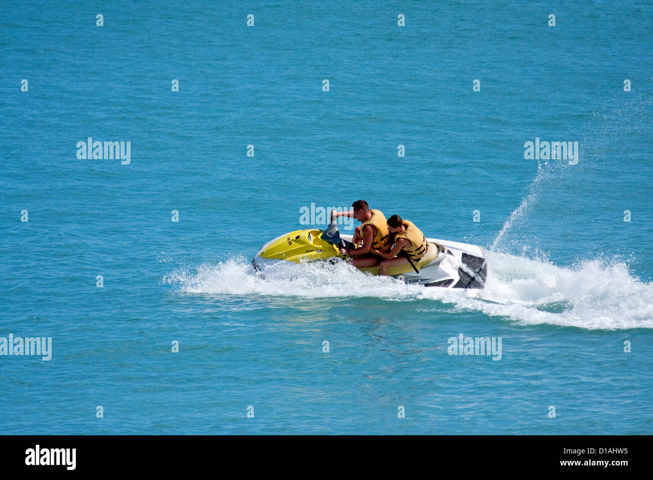 Duo jet skiing in tropical waters Stock Photo