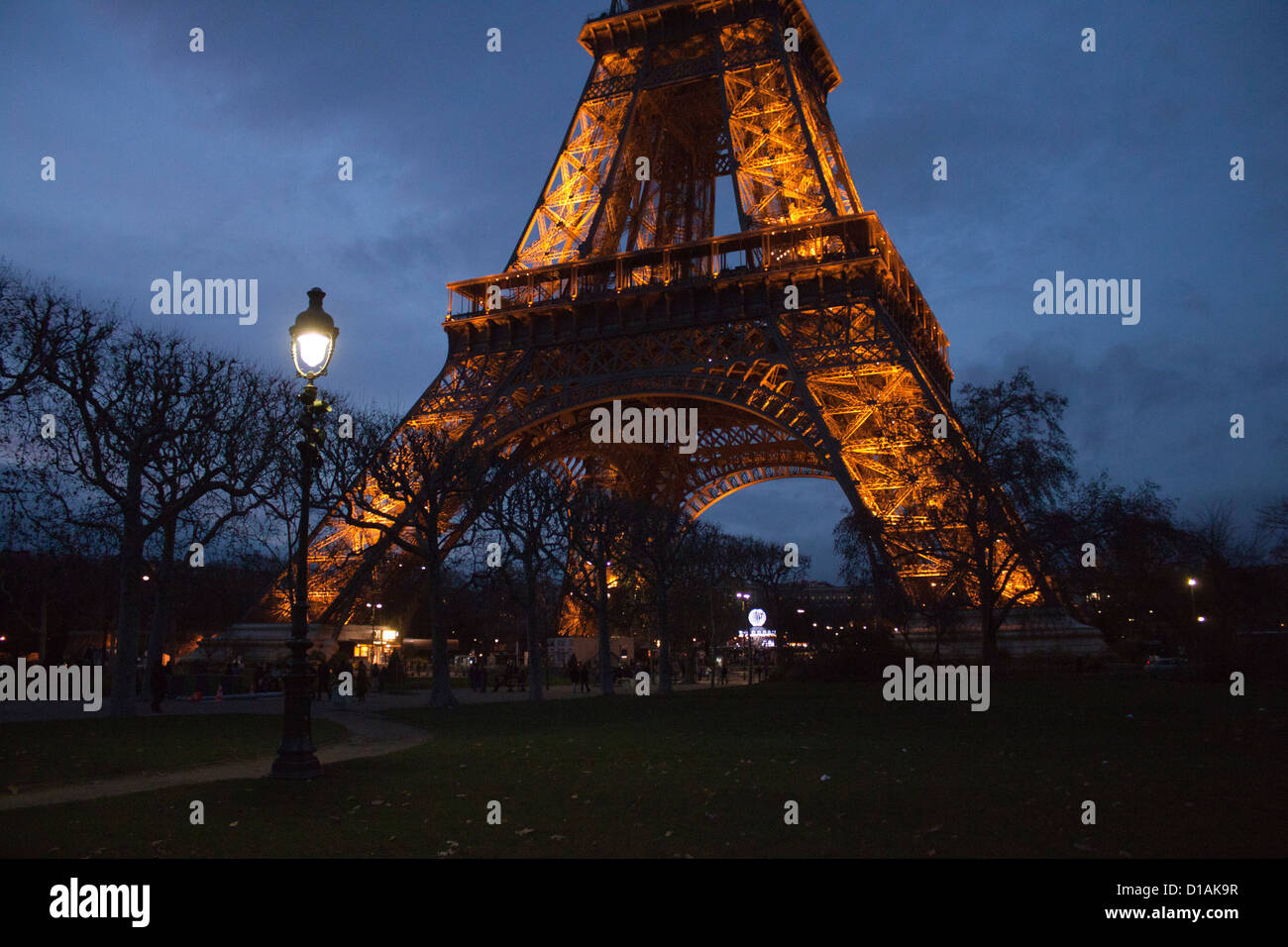 Yellow Eiffel Tower at night after blue sunset with street lights, France Paris Stock Photo
