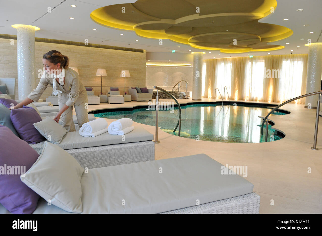 A woman prepares daybeds in the spa area of the Waldorf Astoria at the Zoo in Berlin, Germany, 12 December 2012. The last construction works in the high rise are in the process of being completed. Trial operations have already begun. The first Waldorf Astoria in Germany was supposed to open one year ago. Photo: PAUL ZINKEN Stock Photo
