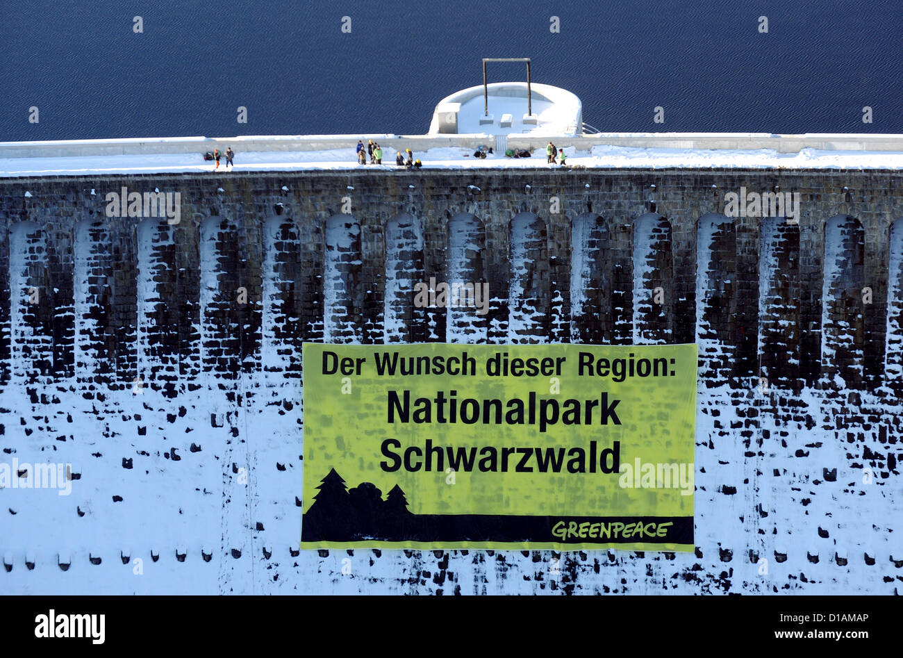 Greenpeace activists have put up a huge banner at Schwarzenbach dam near Forbach, Germany, 12 December 2012. Ten climbers of Greenpeace attached the 28*15 m big banner to the dam to promote the Black Forest National Park. Photo: JAN-PHILIPP STROBEL Stock Photo