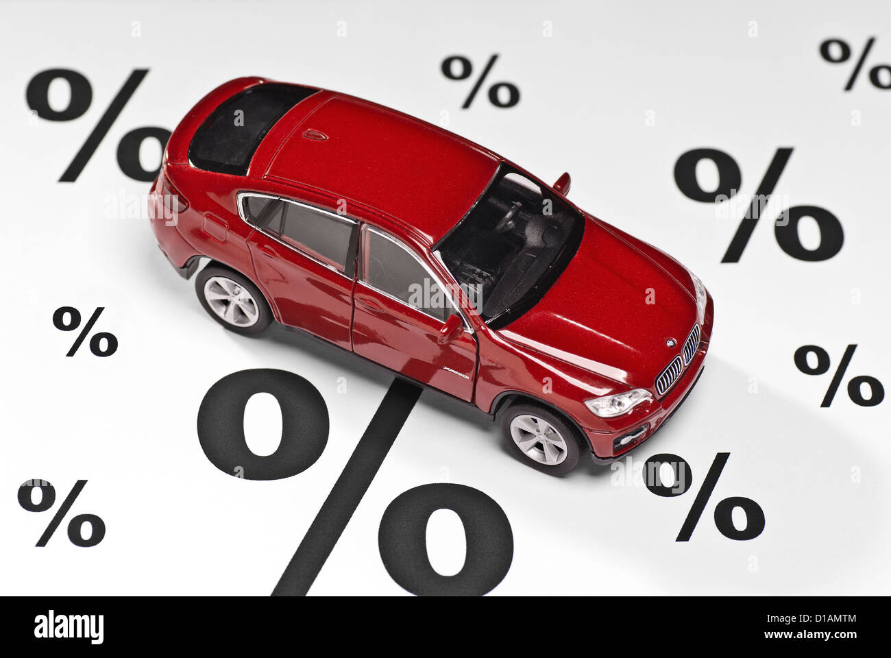 Car with percent sign as symbol for discounts when buying a car. Stock Photo