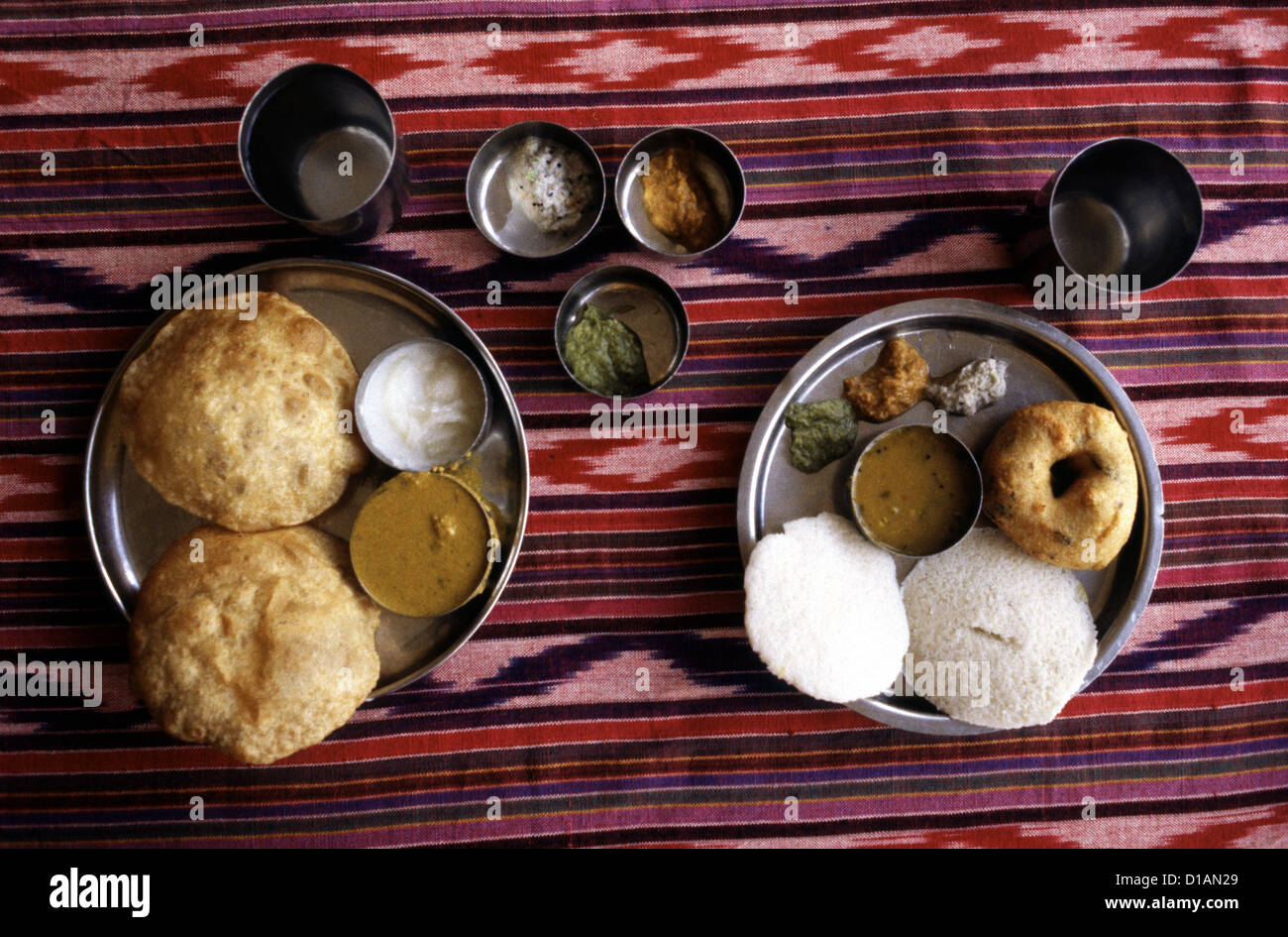 Dish of Puri unleavened deepfried bread and Idli steamed rice cake