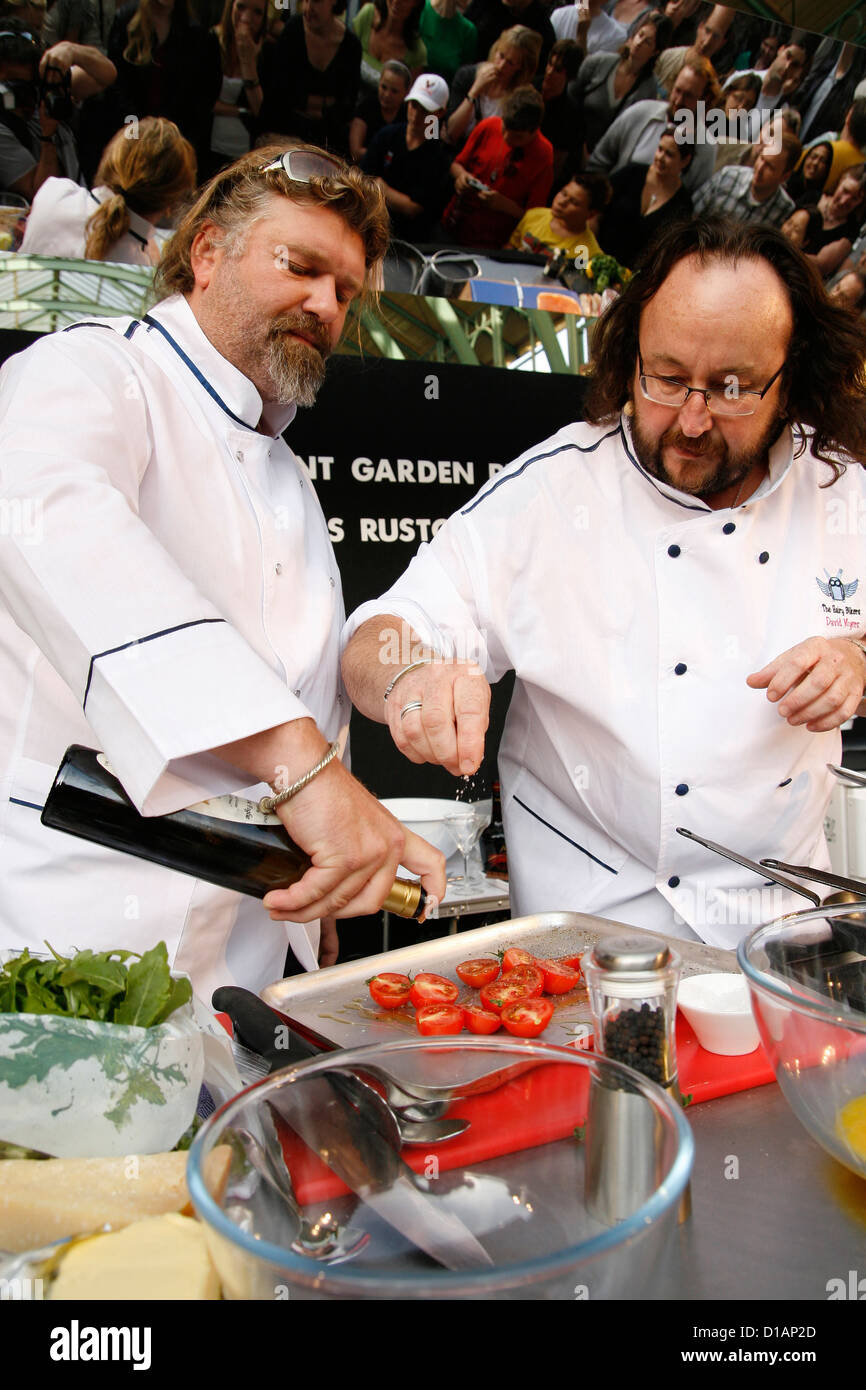 TV chefs The Hairy Bikers Simon King (front) and David Myers cooking in Covent Garden London Stock Photo