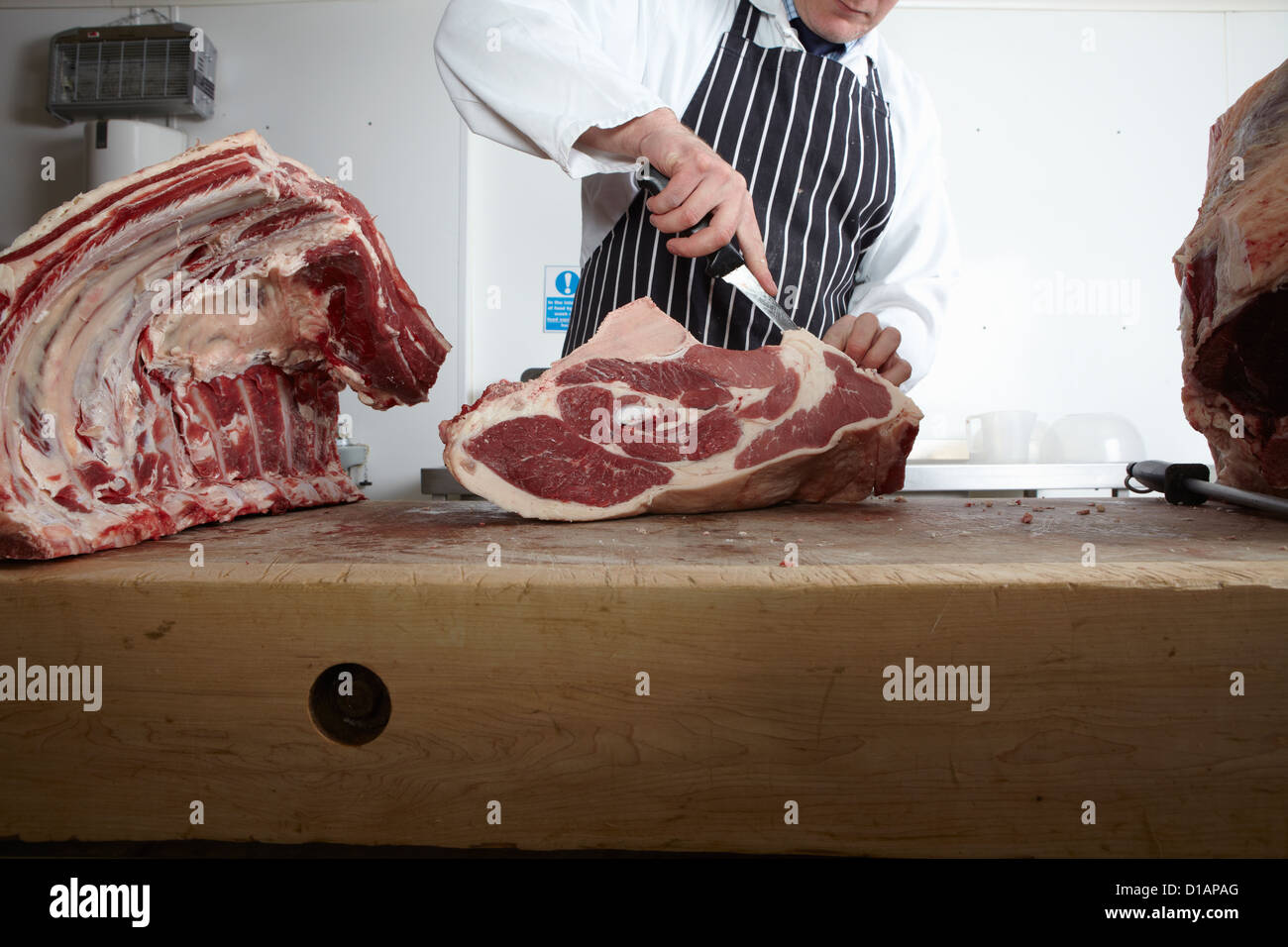 butcher cutting meat Stock Photo