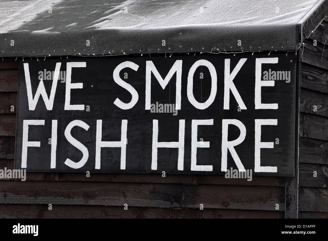 Amusing humorous sign, We Smoke Fish Here, smokery fish preservation