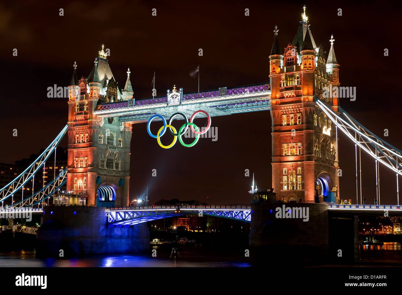 Tower Bridge is illuminated gold, to celebrate British rowers, Heather Stanning and Helen Glover, for winning the gold medal. Stock Photo