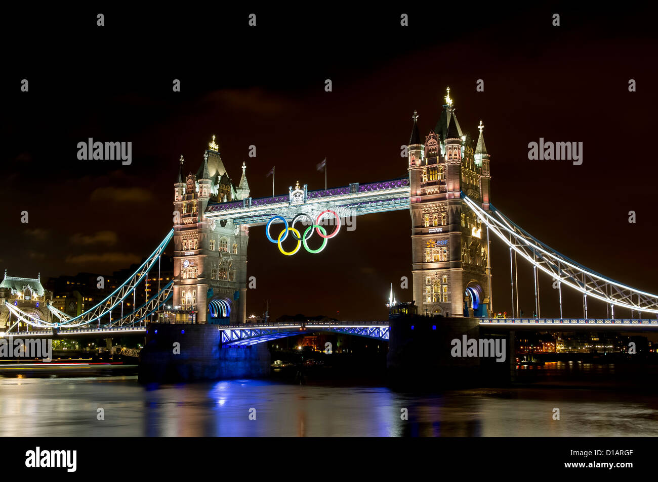 Tower Bridge is illuminated gold, to celebrate British rowers, Heather Stanning and Helen Glover, for winning the gold medal. Stock Photo