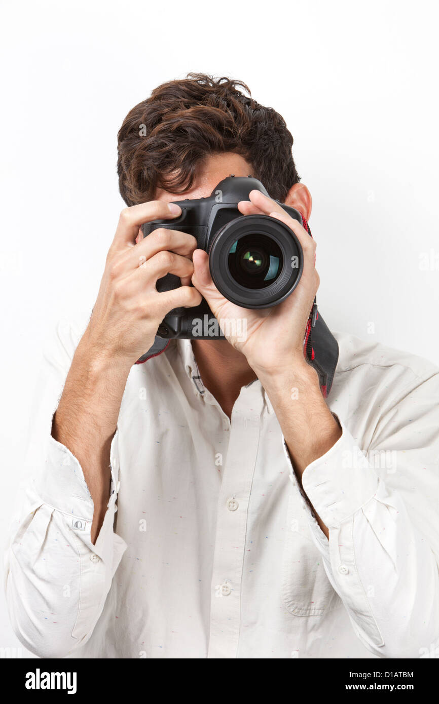Young man taking photograph retro style camera Stock Photo