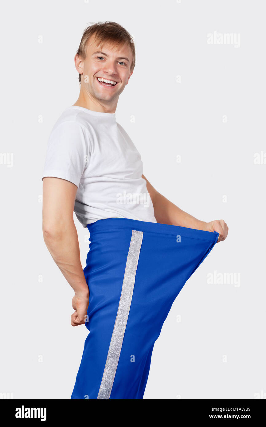 Portrait young man in oversized blue pants Stock Photo