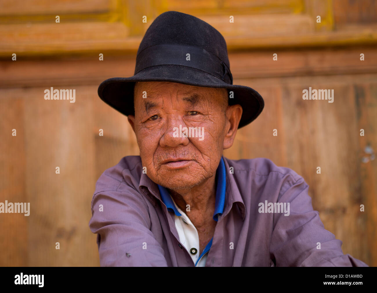 Man Sit In The Street, Bai Village Of Shaxi, Yunnan Province, China Stock Photo