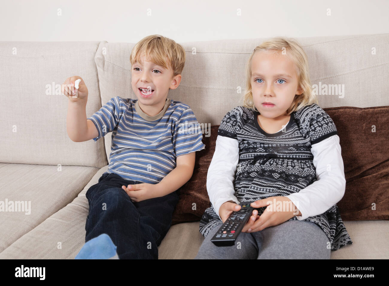 brother sister watching television Stock Photo
