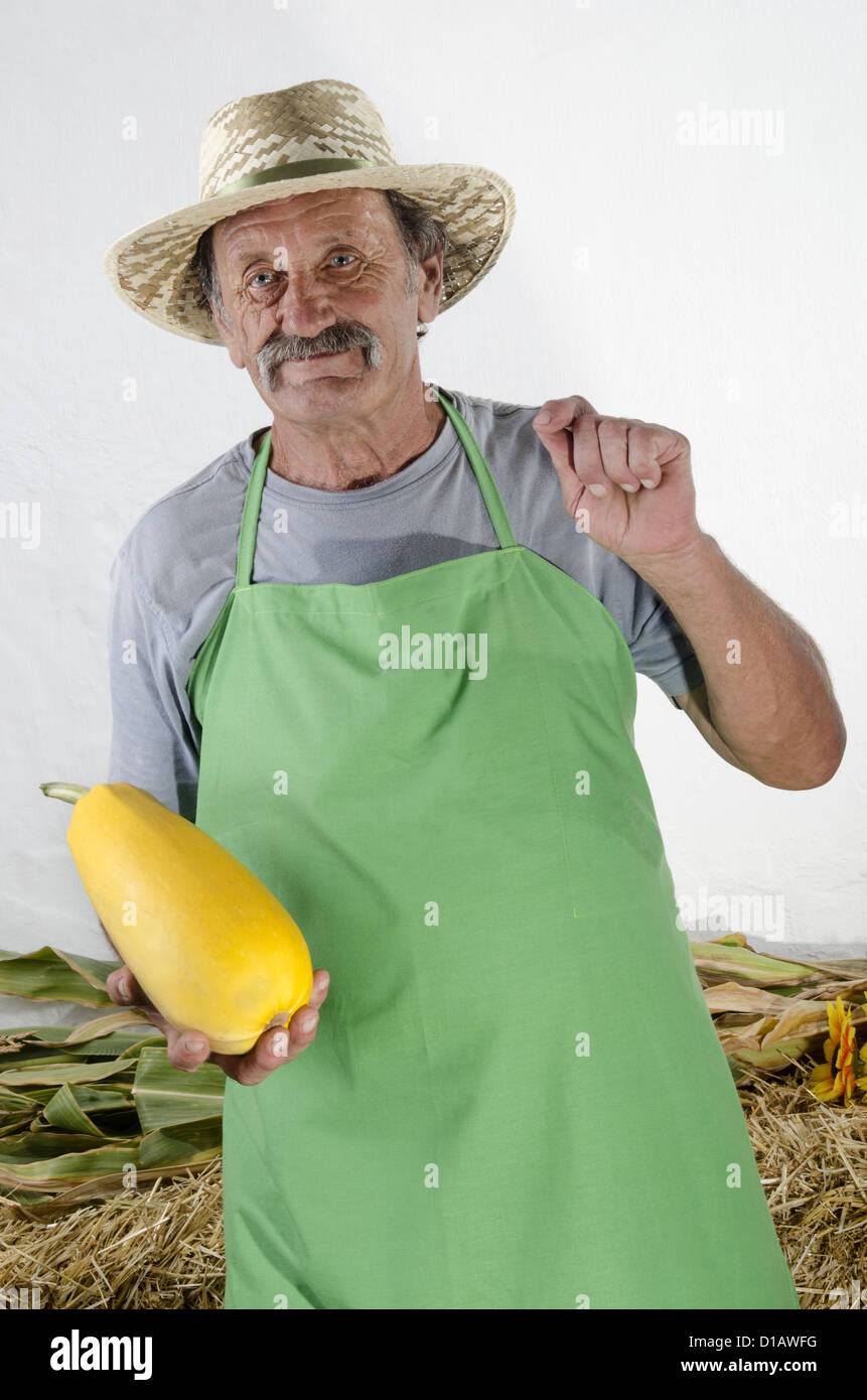 farmer with a yellow organic pumpkin in his hand Stock Photo - Alamy