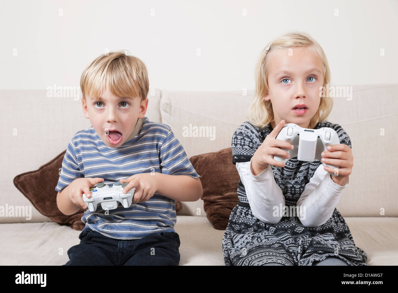 Young brother sister playing video game Stock Photo Alamy