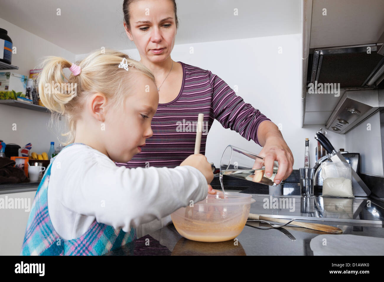 mother daughter cooking in kitchen Stock Photo