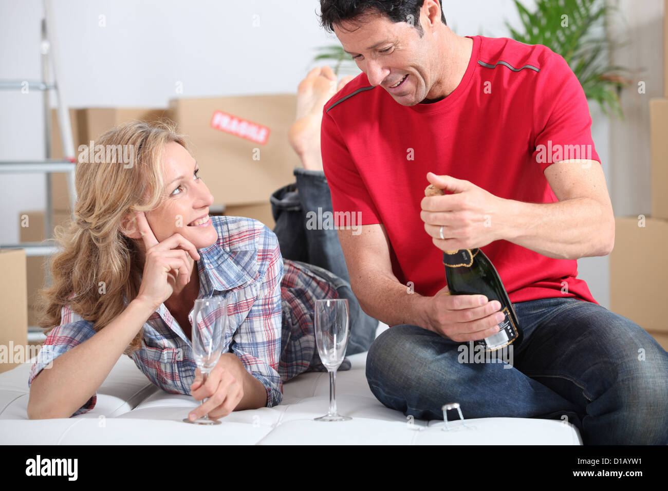 Couple drinking champagne in new home Stock Photo