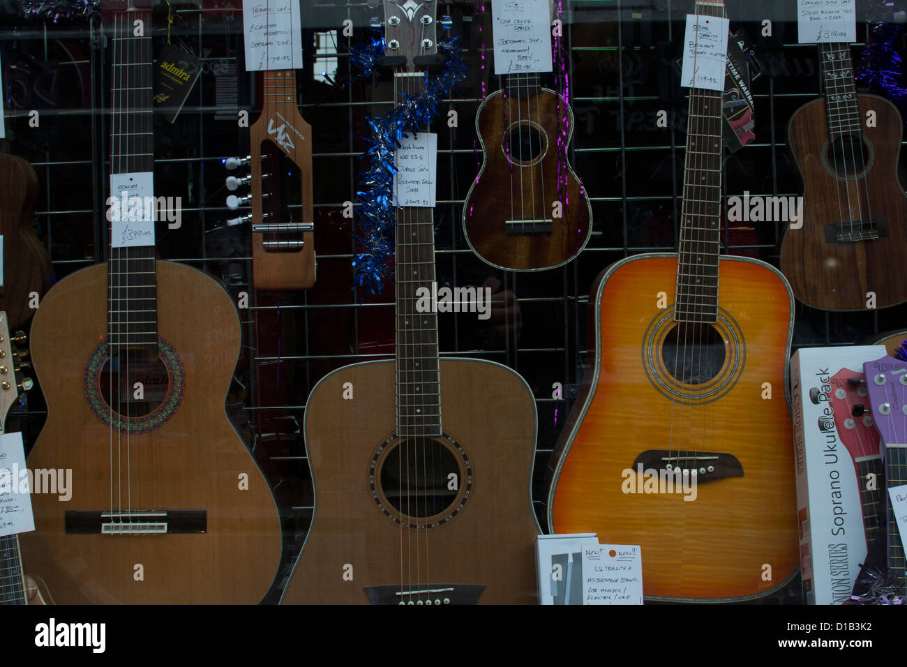 Guitars in a shop window of a music store Stock Photo