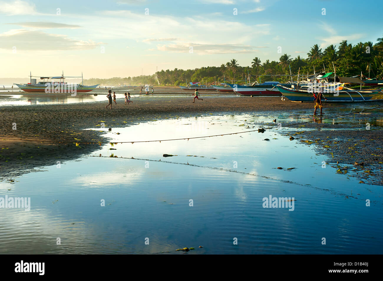 Children playing on the beach in the small Philippines village. Stock Photo
