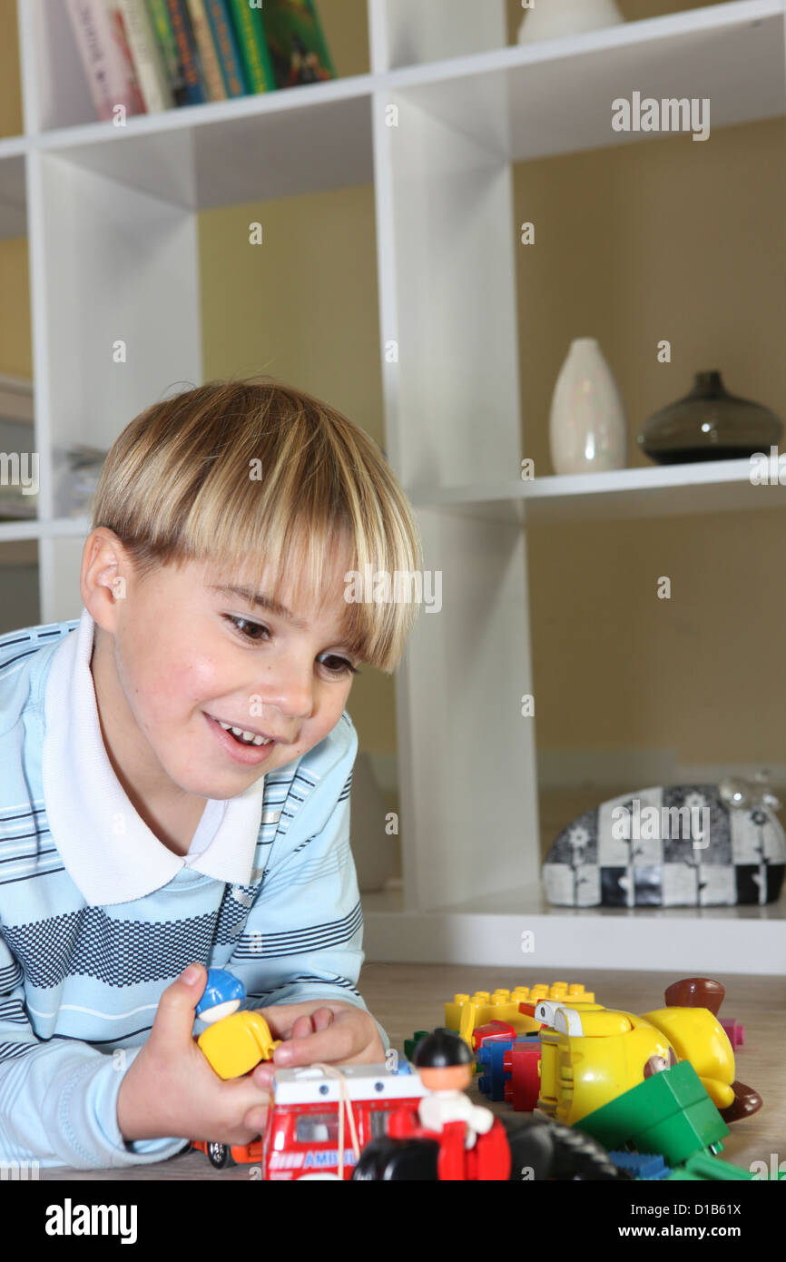 Little boy playing with his toys Stock Photo - Alamy